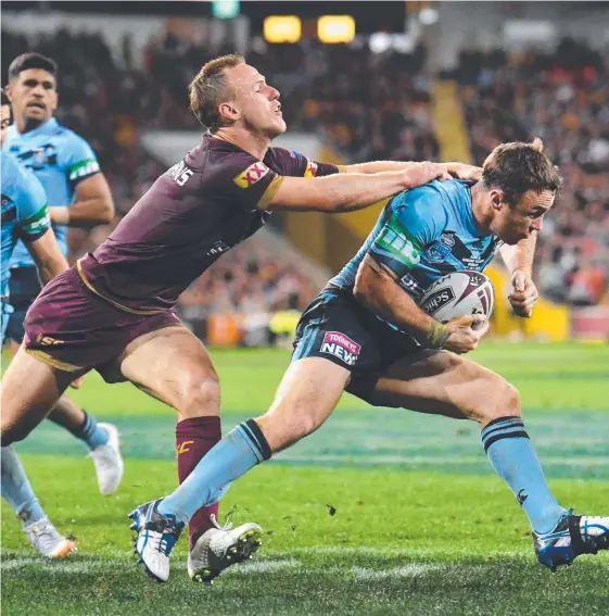  ?? Picture: AAP IMAGE ?? Daly Cherry-Evans (left) holds on to Blues playmaker James Maloney in the Origin final. The Maroon now wants to hold on to his own jumper.