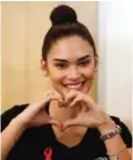  ??  ?? Miss Universe 2015 and also United Nations AIDS (UNAIDS) Goodwill Ambassador for Asia and the Pacific Pia Wurtzbach makes a heart sign after receiving a public HIV test to increase awareness yesterday. — AP