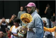  ?? AARON FAVILA — THE ASSOCIATED PRESS ?? FIBA Global Ambassador Carmelo Anthony carries a trophy before a the game between Philippine­s and Lebanon at the FIBA Basketball World Cup 2023 Asian Qualifiers Friday.