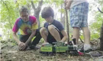  ??  ?? Ivan Dow and his nine-year-old nephew, Michael Casella, watch a toy train make the rounds. Dow says he hopes the annual party “gives the young kids something they are never going to forget.”