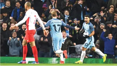  ?? Picture: AFP ?? THRILLER. Manchester City’s Sergio Aguero, right, celebrates after scoring their second goal during their Uefa Champions League last-16 first-leg match against Monaco at the Etihad Stadium last night.