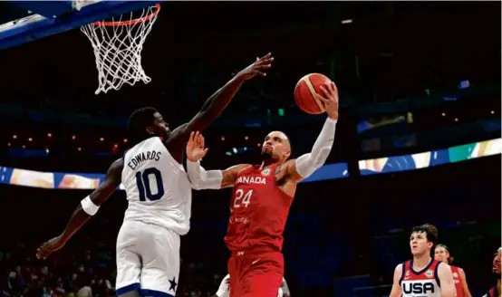  ?? TED ALJIBE/AFP VIA GETTY IMAGES ?? Anthony Edwards (left) and his US teammates failed to stop Dillon Brooks (39 points) and Canada in the third-place game.