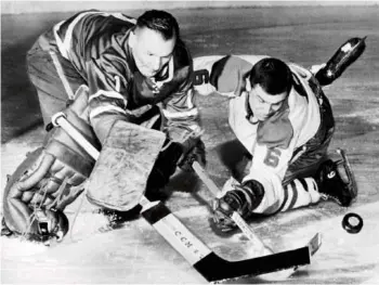  ?? MONTREAL GAZETTE FILES ?? Toronto Maple Leafs goaltender Johnny Bower reaches out with his famous poke check to knock the puck away from Montreal Canadiens’ forward Ralph Backstrom during a game in 1964.