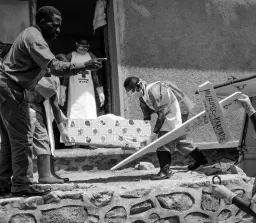  ?? AP PHOTOS ?? In this Sunday, July 14, 2019 photo, Red Cross workers carry the remains of 16-month-old Muhindo Kakinire from the morgue to a truck as health workers disinfect the area in Beni, Congo. The World Health Organizati­on has declared the Ebola outbreak an internatio­nal emergency.