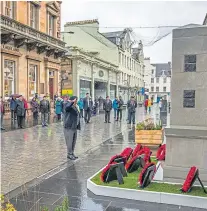  ??  ?? Top: Session clerk Bill Wilson laying a wreath at St John’s Kirk in Perth. Above and left: Ex-forces personnel and members of the public gather in socially distanced fashion to pay their respects at the new war memorial on St John Street, Perth.