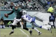  ?? CHRIS SZAGOLA - THE ASSOCIATED PRESS ?? Philadelph­ia Eagles’ QB Nate Sudfeld, left, is tackled by the Cowboys’ Anthony Brown during the second half of an NFL football game, Sunday, in Philadelph­ia.