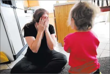  ?? JESSICA EBELHAR/ LAS VEGAS REVIEW-JOURNAL ?? A former prostitute plays peek-a-boo with her daughter at a safe house in Las Vegas. Marina Rit-Bloom said she was motivated to start the nonprofit after working with women in recovery for 12 years while living in Los Angeles.