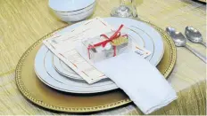  ??  ?? WELCOME: Each place setting had a piece of cake and a pamphlet with details of the wedding ceremony