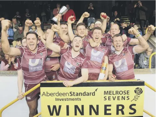  ??  ?? 0 The victorious Watsonians side celebrate with the trophy after their superb win in the final against hosts Melrose on Saturday.