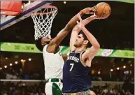  ?? Brandon Dill / Associated Press ?? Grizzlies forward Santi Aldama (7) shoots against Celtics guard Jaylen Brown on Sunday.