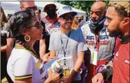  ?? Dan Gelstoin / Associated Press ?? NASCAR driver Kyle Larson, center, talks with members of the Urban Youth Racing School before the start of a race on the grounds of the Please Touch Museum in Philadelph­ia on Friday.