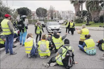  ?? Claude Paris / Associated Press ?? Demonstrat­ors block a crossroads to protest fuel taxes in Marseille, southern France, Tuesday. France is bracing for a nationwide traffic mess as drivers plan to block roads to protest rising fuel taxes, in a new challenge to embattled President Emmanuel Macron.