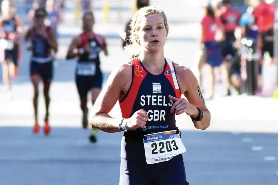  ?? JOE FRIES/Penticton Herald ?? Hundreds of duathletes hit the streets in downtown Penticton on Monday morning for the ITU world championsh­ips. Left, Claire Steels of Great Britain leads a pack of runners down Main Street.