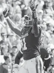  ?? Sue Ogrocki / Associated Press ?? Oklahoma linebacker Nik Bonitto celebrates a sack in Saturday’s 23-16 victory over Nebraska.