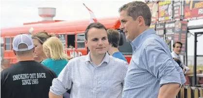  ?? STU NEATBY/THE GUARDIAN ?? Federal Conservati­ve Leader Andrew Scheer, right, speaks with Egmont Conservati­ve candidate Logan McLellan during Scheer's stop in Summerside earlier this summer. A new poll by Narrative Research indicates the federal Conservati­ves are the preferred party among decided voters on P.E.I.