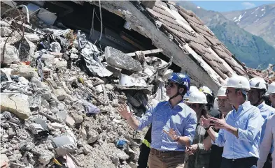  ?? Prime Minister Justin Trudeau listens to Italy’s Foreign Affairs Minister Angelino Alfano during a visit to Amatrice, Italy, a medieval town that was destroyed in an earthquake last August. ?? EMILIANO GRILLOTTI / AFP / GETTY IMAGES