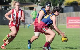  ??  ?? Right: Youth Girls Emily Hobbs gathers the ball before kicking a much needed goal.