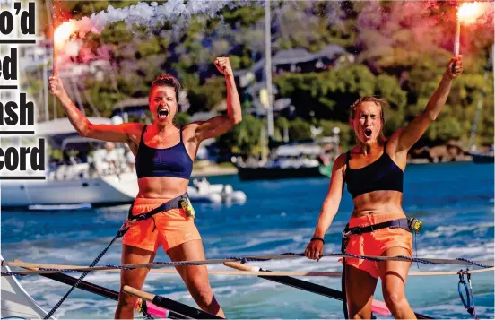  ?? ?? Flares up: Jessica Oliver, left, and Charlotte Harris celebrate their world record in Antigua after completing 3,000-mile challenge