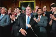  ?? JACQUELYN MARTIN/AP PHOTO ?? House Ways and Means Chair Rep. Kevin Brady, R-Texas, center, is welcomed by House Republican­s including, from left, House Majority Leader Kevin McCarthy of California, House Speaker Paul Ryan of Wisconsin, Rep. Carlos Curbelo, R-Fla., and Rep. Cathy...