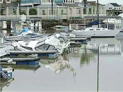  ?? Picture: NICCI HAYES ?? UNDER WATER: Three boats sank in the Port Alfred Marina after their covers were ripped off by near-galeforce winds on the night of August 7.