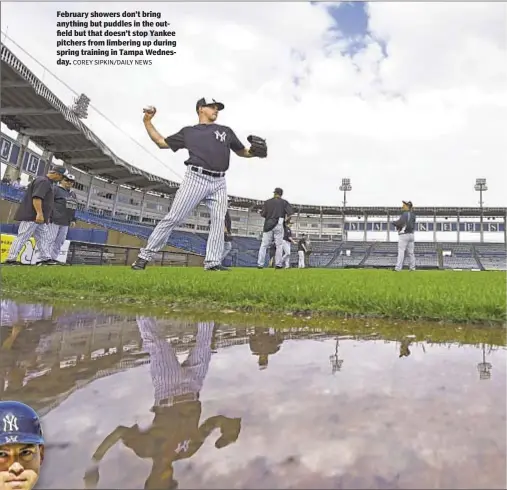  ?? COREY SIPKIN/DAILY NEWS ?? February showers don’t bring anything but puddles in the outfield but that doesn’t stop Yankee pitchers from limbering up during spring training in Tampa Wednesday.