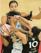  ?? AP ?? Aces Kelsey Plum and teammate tie up Liberty’s Jonquel Jones during Game 2 rout on Wednesday in Las Vegas.