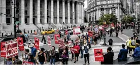  ?? JEENAH MOON / THE NEW YORK TIMES ?? Union demonstrat­ors march in New York in June after the U.S. Supreme Court struck down mandatory union fees for government workers. A judge Saturday blocked a White House attempt to make it easier to fifire federal workers.