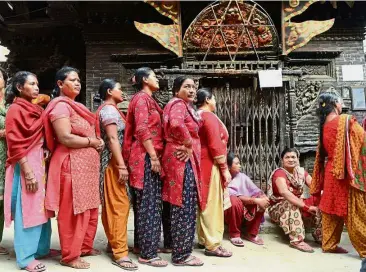  ??  ?? New era: Voters queuing up to cast their ballots at a polling station in Thimi on the outskirts of Kathmandu. — AFP