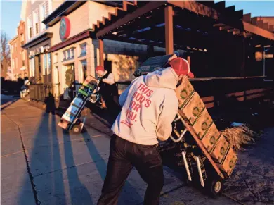  ?? CALVIN MATTHEIS / FOR THE JOURNAL SENTINEL ?? Jim Marron of Beechwood Sales and Service delivers beer Friday to Leff’s Lucky Town. Bars and restaurant­s across the state are prepping for a busy New Year’s weekend that features Packers and Badgers games. For more photos, go to jsonline.com/news.