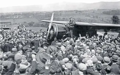  ??  ?? A crowd in Londonderr­y cheers for Amelia Earhart – the first woman to fly across the Atlantic alone