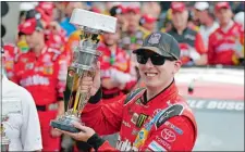  ?? MICHAEL CONROY/AP PHOTO ?? Kyle Busch celebrates after winning the NASCAR Sprint Cup Brickyard 400 at Indianapol­is Motor Speedway on Sunday.