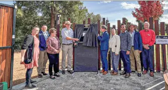  ?? PHOTO: CONTRIBUTE­D ?? The Wellington Library Outdoor Living Room was officially opened to the public last weekend. Pictured either side of the ceremonial curtain are Member for Calare Andrew Gee (left) and Dubbo mayor Mathew Dickerson, along with Dubbo Regional councillor­s.