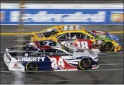  ?? STEVE HELBER — THE ASSOCIATED PRESS ?? William Byron (24) and Kyle Busch (18) race during the NASCAR Cup series race in Richmond, Va., last Saturday.