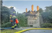  ?? ARLEN REDEKOP/PNG ?? A fire early Sunday caused quite a bit of damage to a protected heritage Shaughness­y mansion on Angus Drive.