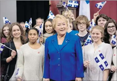  ?? JACQUES BOISSINOT/ THE CANADIAN PRESS ?? Premier Pauline Marois poses with students at a ceremony marking the 65th anniversar­y of the Quebec flag Monday.