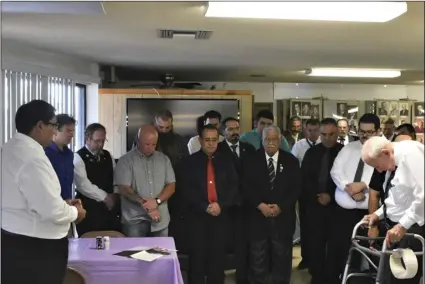  ?? PHOTO TOM BODUS ?? Local and visiting Masons and guests give thanks before a dinner celebratin­g the merger of Imperial Lodge 390 with Brawley Lodge 402. Lodge Master Kelly Ranasinghe is pictured on the far left. The lodge’s oldest member, Thomas Remington, 91, is shown on the far right.