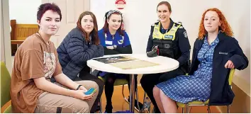  ?? ?? Above: Acting sergeant Kiara Roffey talks to Juan-Mari De Villers from Drouin Secondary College, Hayley Leunie and Ezz Jessopp from Lowanna College, and Makaela Hallyburto­n from Chairo Christian School.