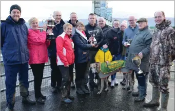  ??  ?? Ina and Tim Galvin, from Gally’s Bar, Rose and the O’Driscoll family after Timmy’s Dog, Skelligh Shane, won the Kingdom Cup at Ballybegga­n coursing