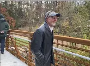  ?? LISA SCHEID — READING EAGLE ?? Ted Coffelt, president of the Hay Creek Watershed Associatio­n, celebrates the opening of the Hay Creek pedestrian bridge Monday at Rustic Park that he had worked to see finished for many years, along with many of the supporters of the project.