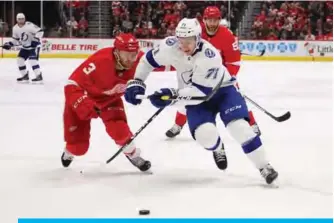  ??  ?? DETROIT: Anthony Cirelli #71 of the Tampa Bay Lightning tries to get around Nick Jensen #3 of the Detroit Red Wings during the third period at Little Caesars Arena on Tuesday in Detroit, Michigan. Tampa Bay won the game 6-5 in a shootout. — AFP
