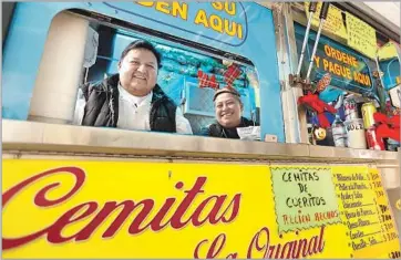  ?? Genaro Molina Los Angeles Times ?? 1. Juan Andrade, left, owner of Cemitas Los Poblanos food truck, and Leonore Rodriguez are all smiles at the order window, but you should know what you want — the line moves fast. (Some advice: You want the tlacoyos.)