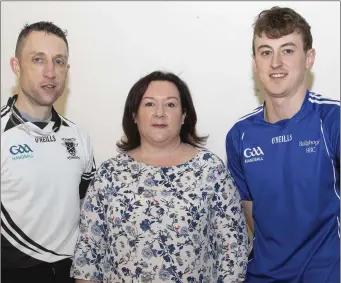  ??  ?? Galen Riordan of Ballyhogue (right), who retained his Senior singles title, with runner-up Gavin Buggy (St. Joseph’s) and Tracey Hogan (Co. Chairperso­n).