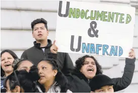  ?? JEFF CHIU/ASSOCIATED PRESS ARCHIVES ?? Lordes Reboyoso, right, yells at a rally outside City Hall in San Francisco. On Tuesday, a federal judge blocked an order to withhold funding from cities that limit cooperatio­n with immigratio­n authoritie­s.