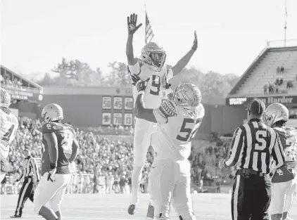  ?? MARY SCHWALM/AP ?? Florida State running back Lawrance Toafili (9) is lifted by teammate Robert Scott Jr. (52) after scoring a touchdown during the first half against Boston College on Saturday in Boston.