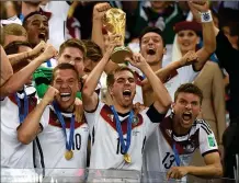  ?? ASSOCIATED PRESS ?? IN THIS JULY 13, 2014, FILE PHOTO, Germany’s Philipp Lahm (16) raises the trophy after the World Cup final soccer match between Germany and Argentina at the Maracana Stadium in Rio de Janeiro, Brazil. After raising the World Cup eight miles from...