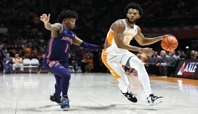  ?? First half of an NCAA ?? Tennessee guard Josiah-jordan James drives past Auburn guard Wendell Green Jr. (1) Saturday during the college basketball game in Knoxville, Tenn. (AP Photo/wade Payne)