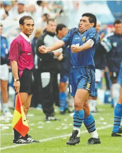  ?? DANIEL GARCIA / AFP via Gett y Images ?? Diego Maradona yells out as he and his teammates celebrate after Argentina scored a goal in their World Cup
match against Greece in 1994.