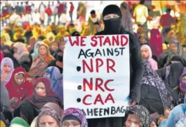  ?? BURHAAN KINU/HT PHOTO ?? A woman holds a placard during a sit-in protest against NPR, NRC and CAA at Shaheen Bagh in New Delhi on February 26.