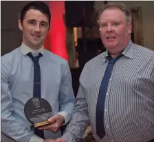  ??  ?? Junior Player of the Year Robert Byrne receives his award from Laurence Ellis.