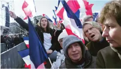  ??  ?? PARIS: Supporters of conservati­ve presidenti­al candidate Francois Fillon waves French flag, during a rally in Paris. — AP